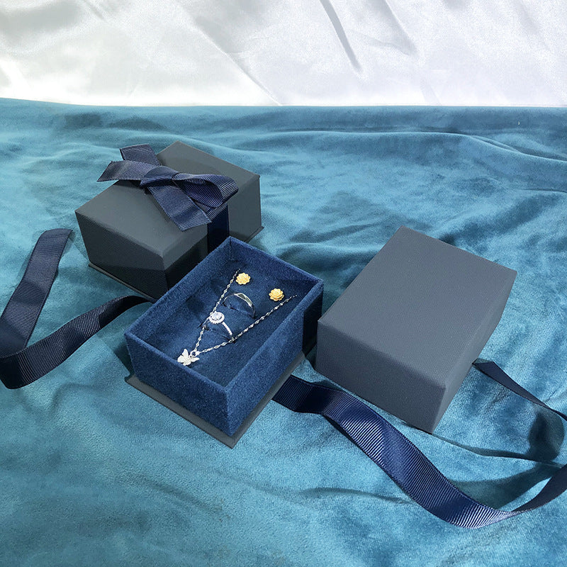 Paper Jewelry Box With Bow Tie Design In Dark Blue, Featuring Love Charms For Elegant Jewelry Packaging
