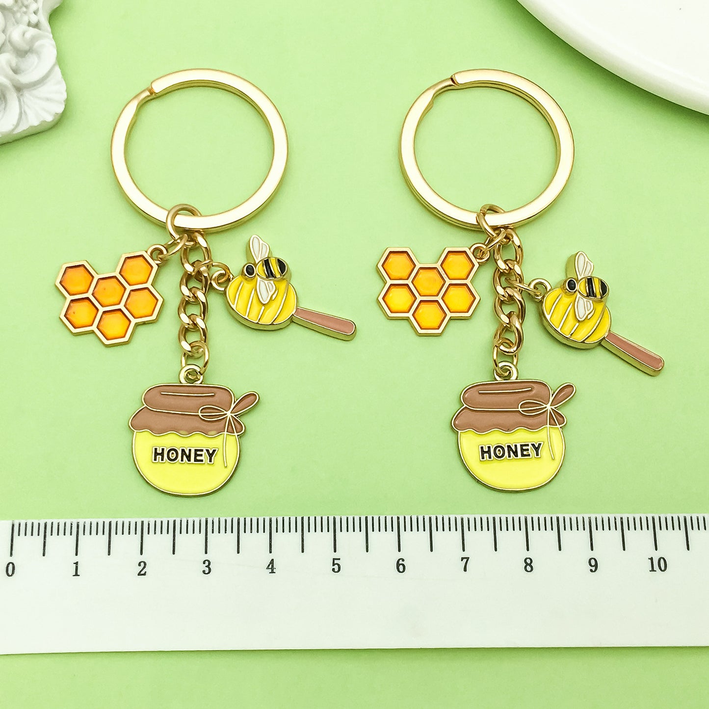 Bee Honeycomb Pendant Featuring A Detailed Bee Pattern In Durable Alloy, Available In Yellow