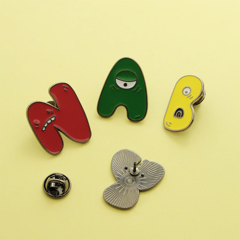 Letter Pin Brooch Featuring Cartoon Design In Durable Zinc Alloy Material