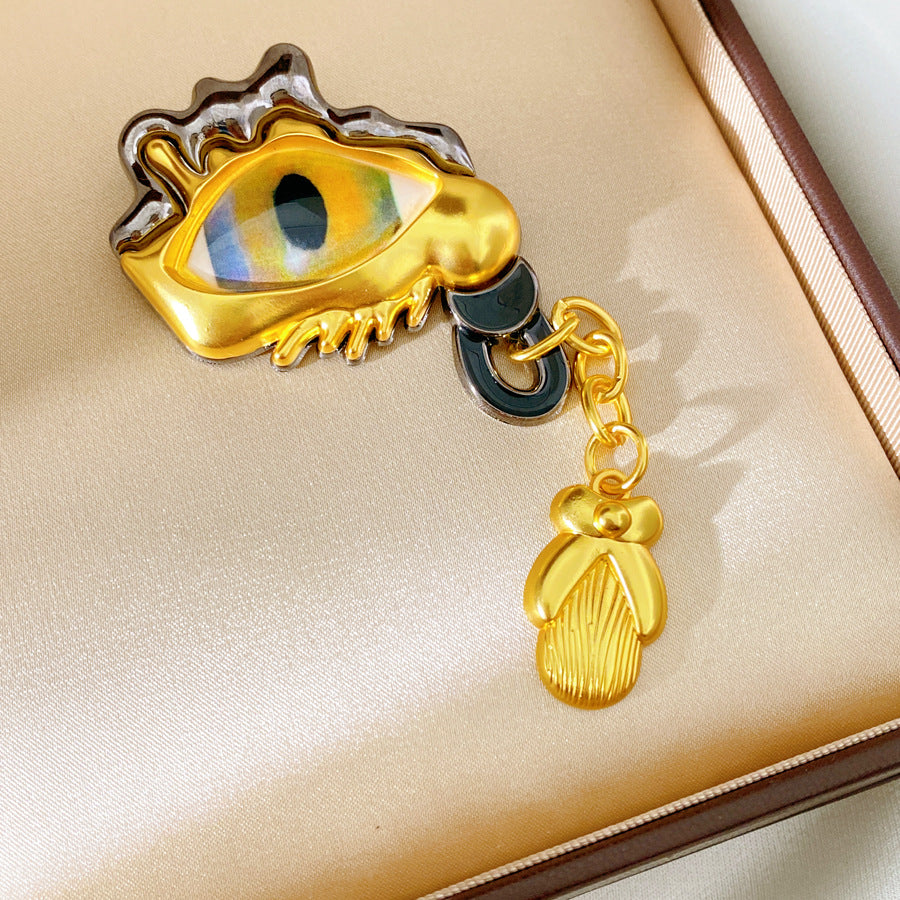 Golden Eye Pin Made Of Resin Featuring Artificial Diamond Inlay