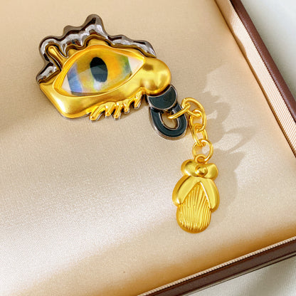 Golden Eye Pin Made Of Resin Featuring Artificial Diamond Inlay