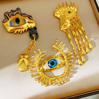 Golden Eye Pin Made Of Resin Featuring Artificial Diamond Inlay