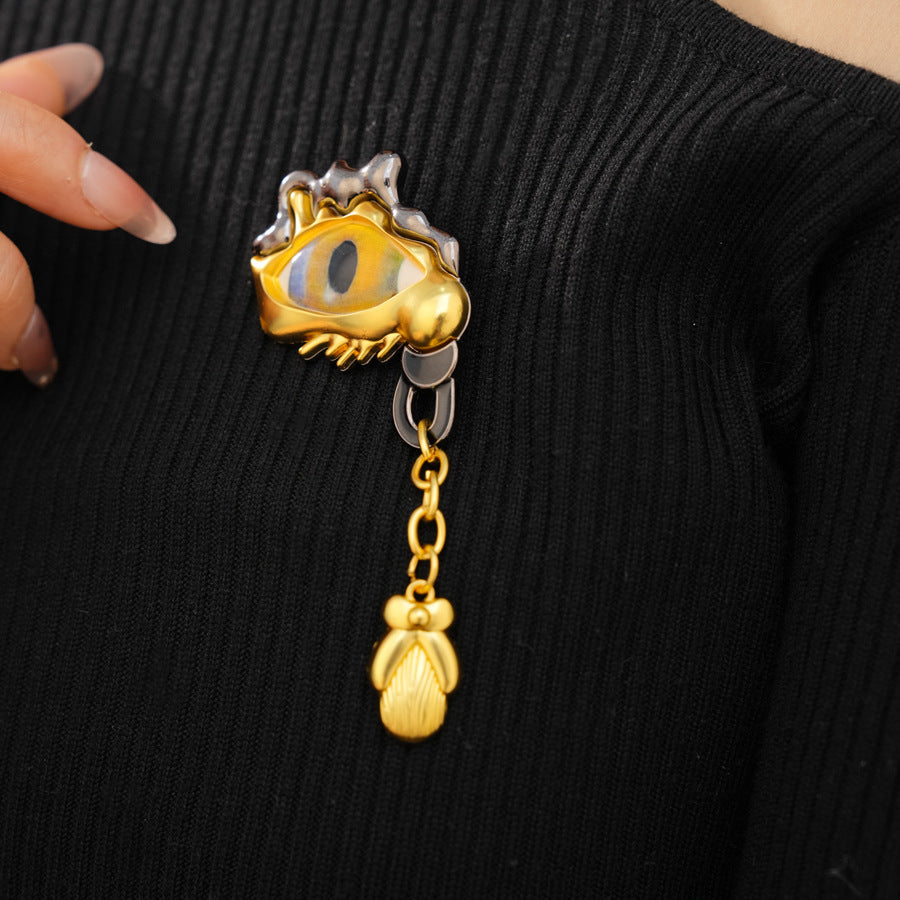 Golden Eye Pin Made Of Resin Featuring Artificial Diamond Inlay