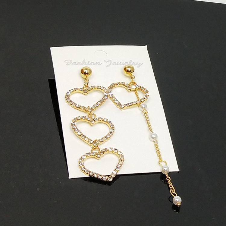Heart Shape Asymmetrical Earrings In Gold Alloy With Electroplated Finish And Rhinestone Inlay