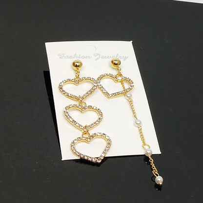 Heart Shape Asymmetrical Earrings In Gold Alloy With Electroplated Finish And Rhinestone Inlay