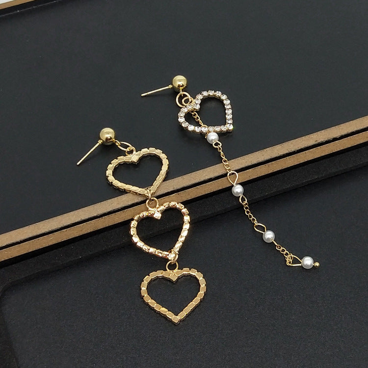Heart Shape Asymmetrical Earrings In Gold Alloy With Electroplated Finish And Rhinestone Inlay