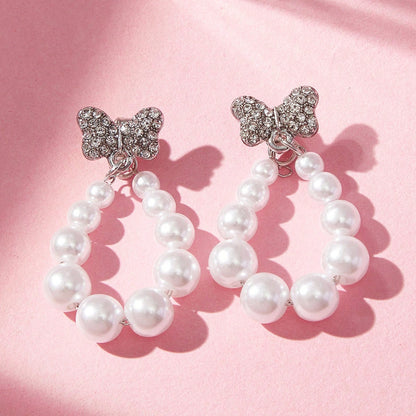 Sweet Silver Bow Tie Stud Earrings For Women With Elaborate Design And Artificial Pearl Inlay In Alloy