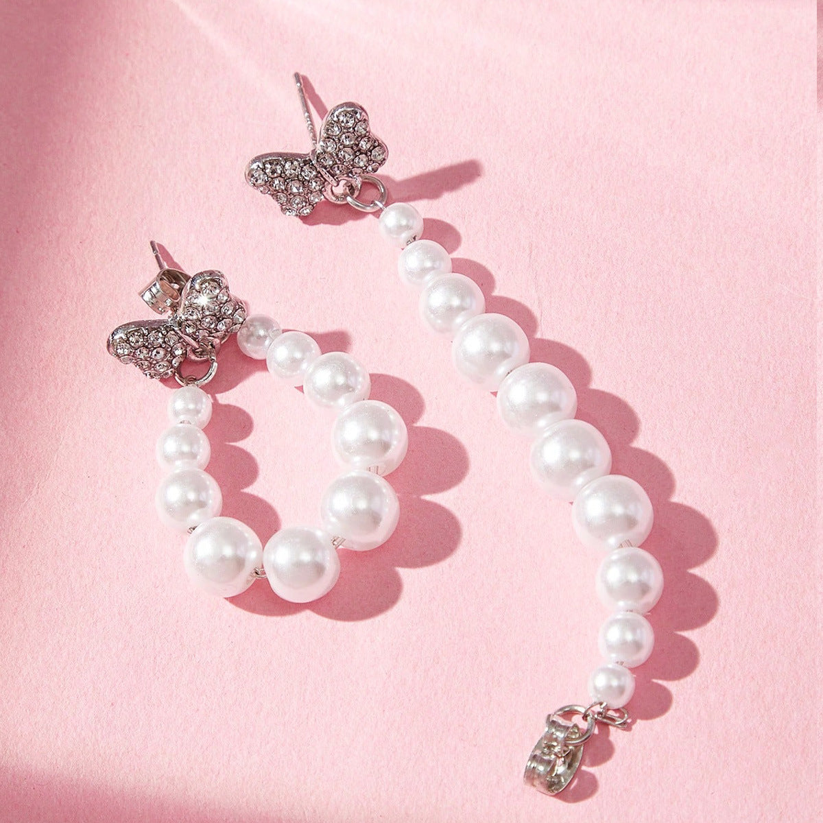 Sweet Silver Bow Tie Stud Earrings For Women With Elaborate Design And Artificial Pearl Inlay In Alloy