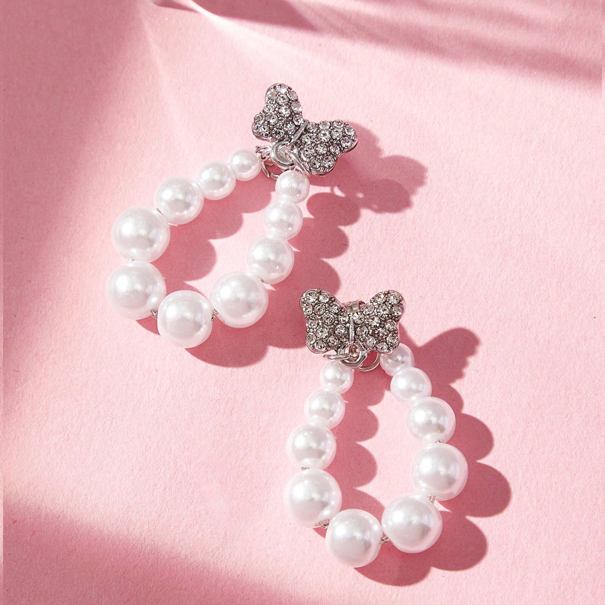 Sweet Silver Bow Tie Stud Earrings For Women With Elaborate Design And Artificial Pearl Inlay In Alloy