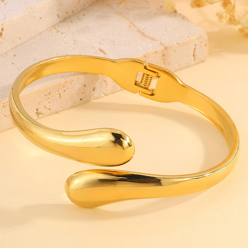 Double Ring Bangle In Titanium Steel With 18K Real Gold Electroplated Finish, Featuring Spring Ring Trigger Clasp Closure In Gold