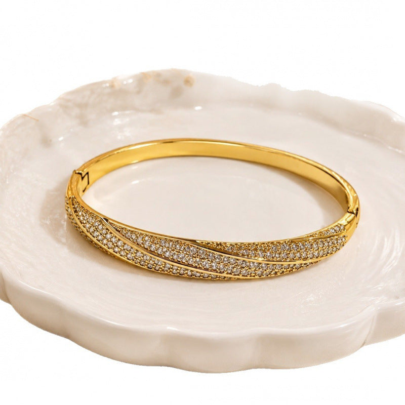 Geometric Twist Bangle In Gold Electroplated Copper Featuring Zircon Inlay