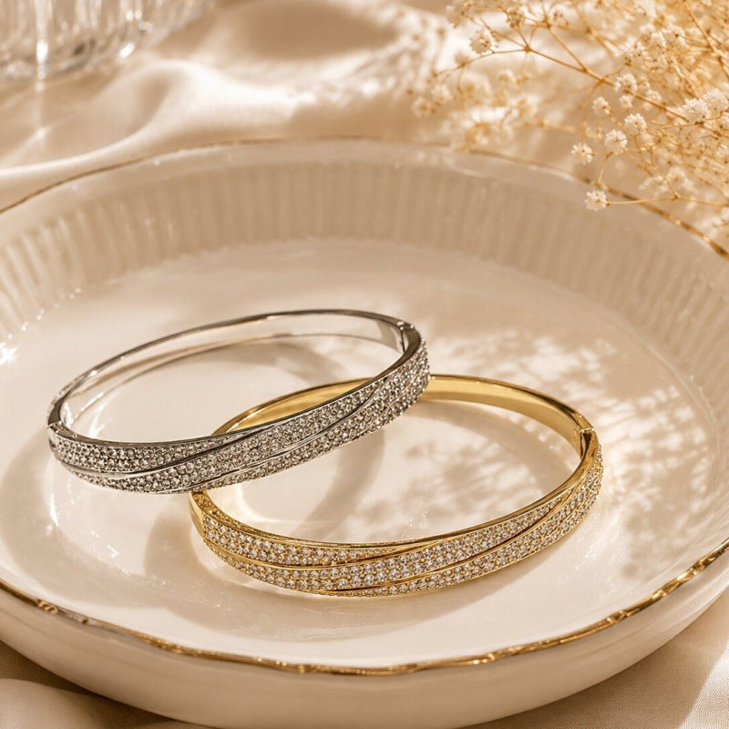 Geometric Twist Bangle In Gold Electroplated Copper Featuring Zircon Inlay