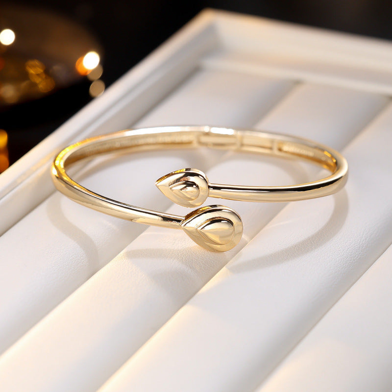 Basic Water Droplets Bangle In Gold With Electroplated Copper Material