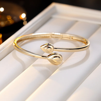 Basic Water Droplets Bangle In Gold With Electroplated Copper Material