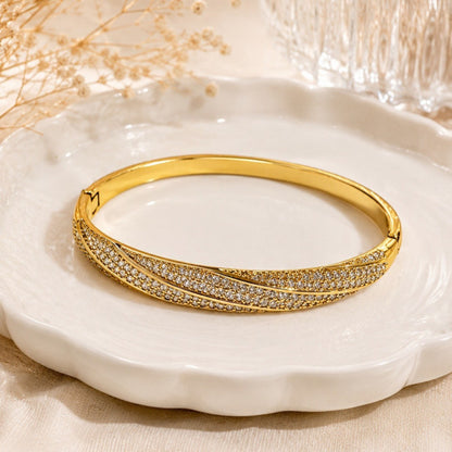 Geometric Twist Bangle In Gold Electroplated Copper Featuring Zircon Inlay