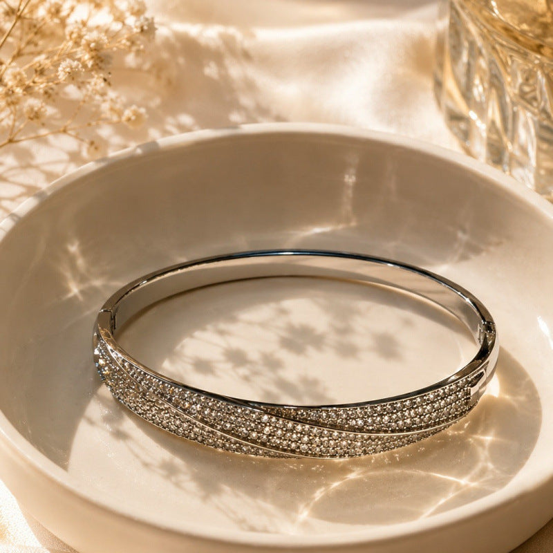 Geometric Twist Bangle In Gold Electroplated Copper Featuring Zircon Inlay