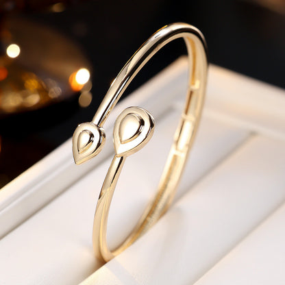Basic Water Droplets Bangle In Gold With Electroplated Copper Material