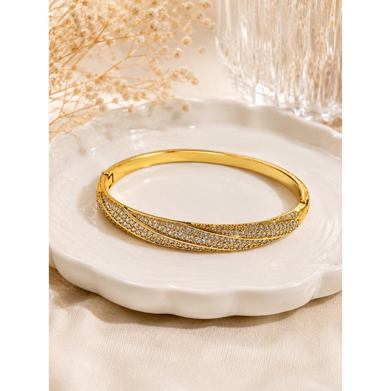 Geometric Twist Bangle In Gold Electroplated Copper Featuring Zircon Inlay