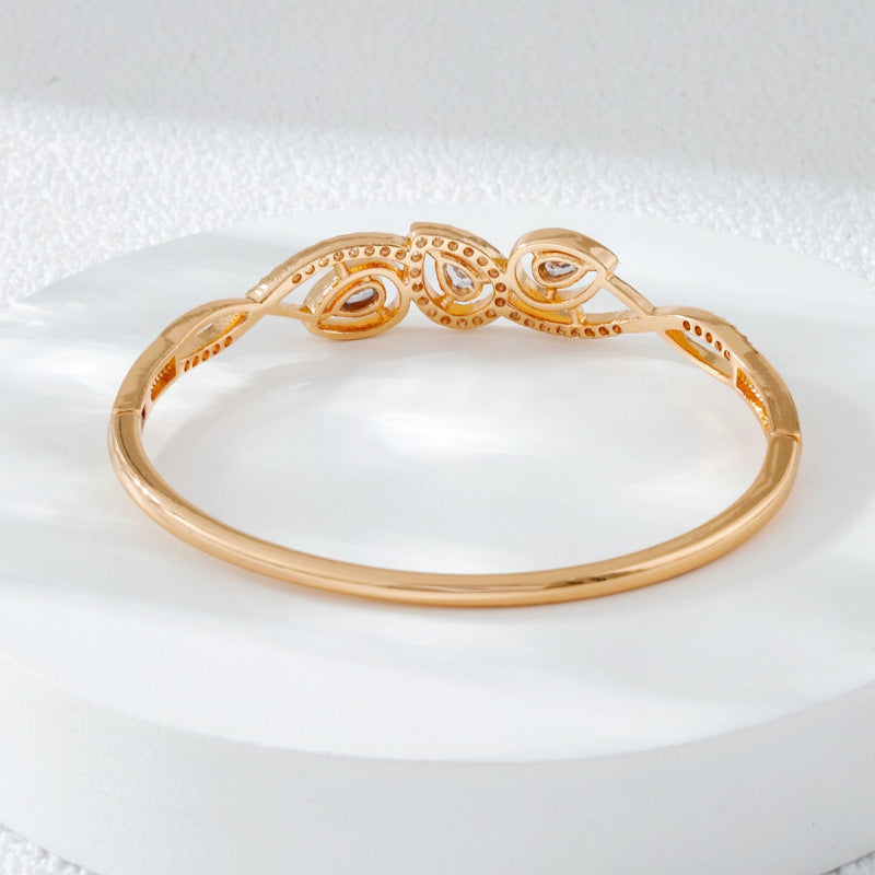 Irregular Inlay Copper Bangle For Women With Electroplated Golden Plated Finish And Zircon Inlay