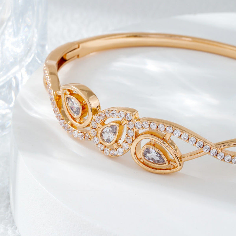 Irregular Inlay Copper Bangle For Women With Electroplated Golden Plated Finish And Zircon Inlay