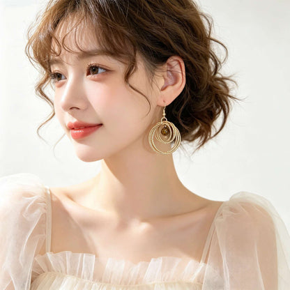 IG Style Round Twist Earrings For Women In KC Golden Plated Metal With 0.03µm Coating Thickness