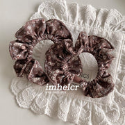 A Pair of Light Brown Floral Hair Ties
