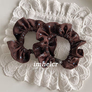 A Pair of Dark Brown and Blue Bow Hair Ties