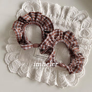 A Pair of Light Brown and White Checkered Hair Ties