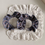 A Pair of Haze Blue, Orange, and White Floral Hair Ties