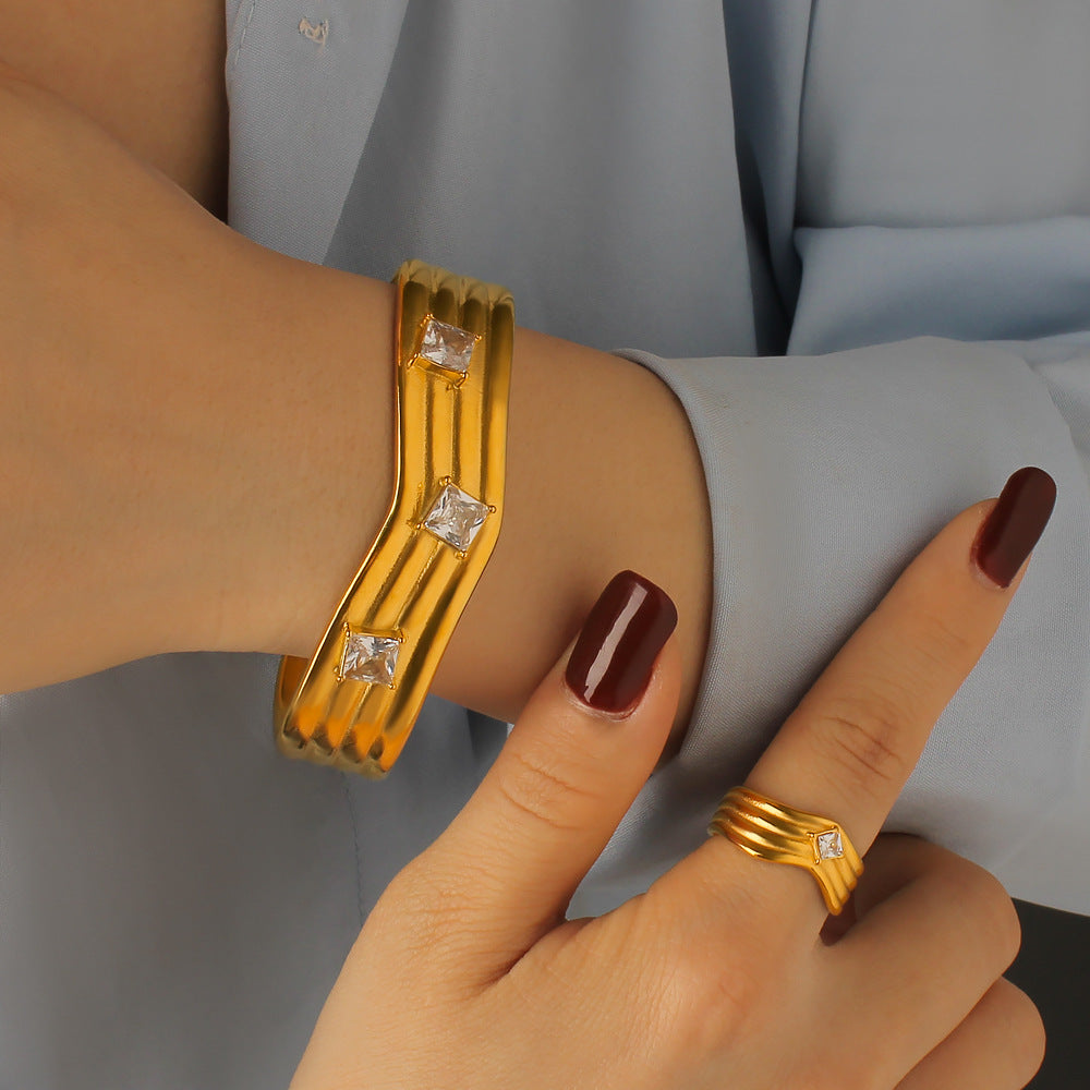 Women’s Titanium Steel Bangle With Golden Plated Finish And Zircon Inlay Featuring Elegant Line Pattern