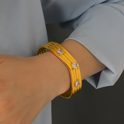 Women’s Titanium Steel Bangle With Golden Plated Finish And Zircon Inlay Featuring Elegant Line Pattern