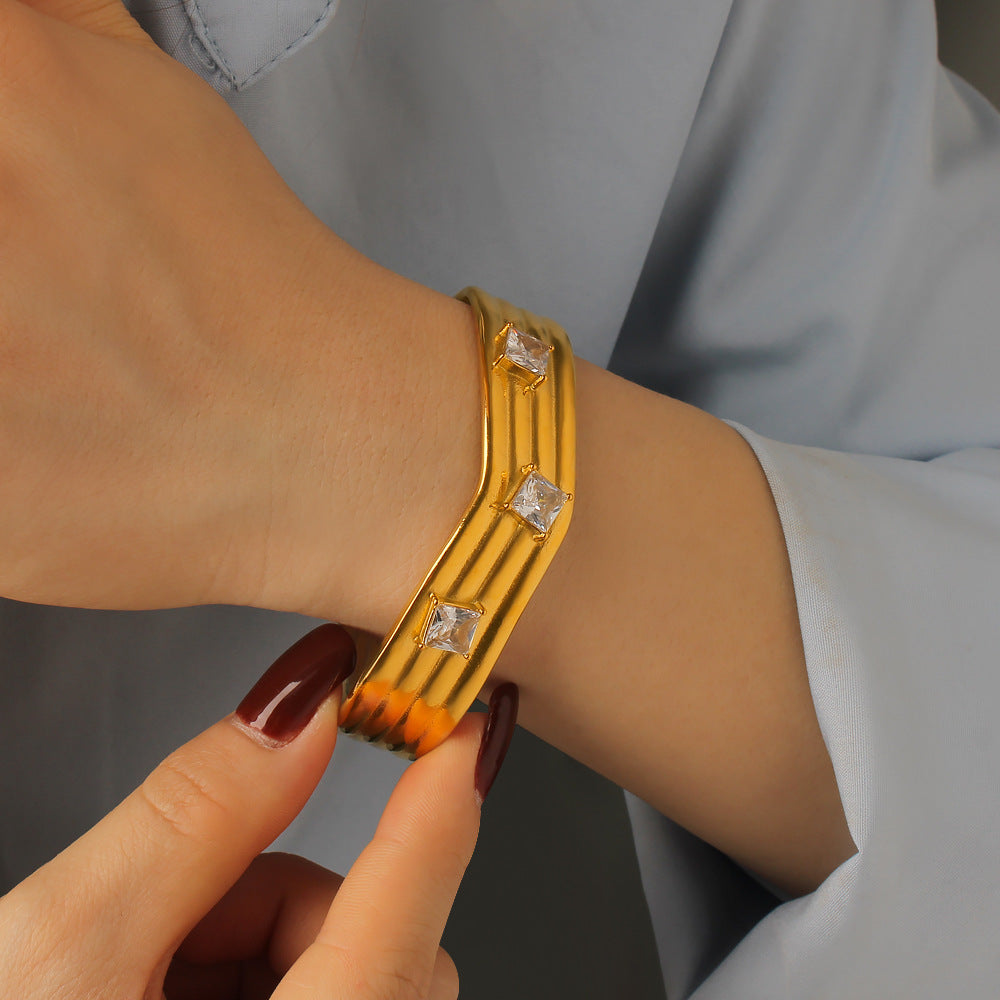Women’s Titanium Steel Bangle With Golden Plated Finish And Zircon Inlay Featuring Elegant Line Pattern