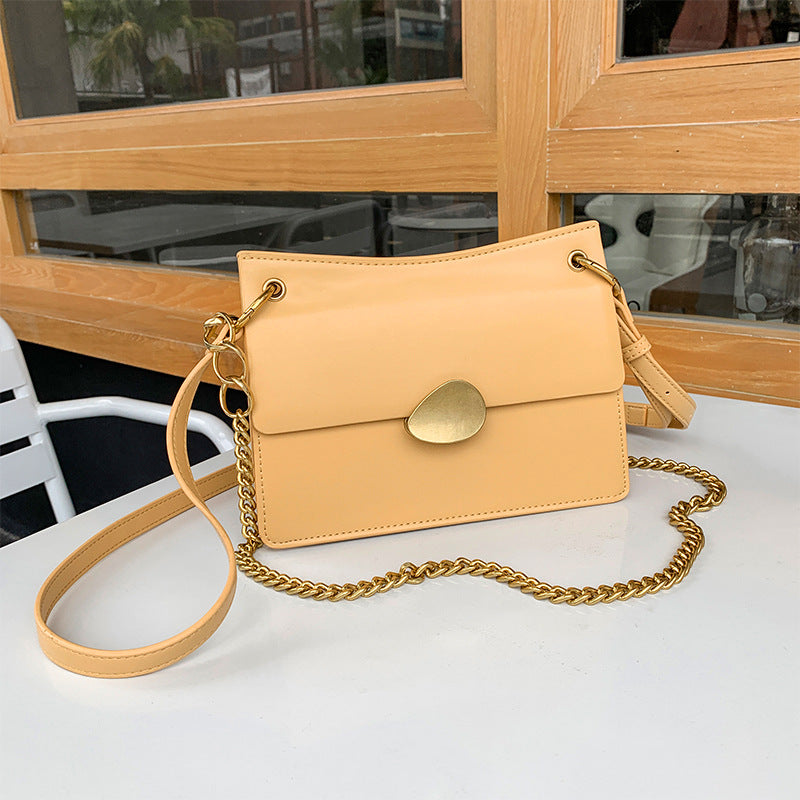 Leather one-shoulder slanted gold lock bag