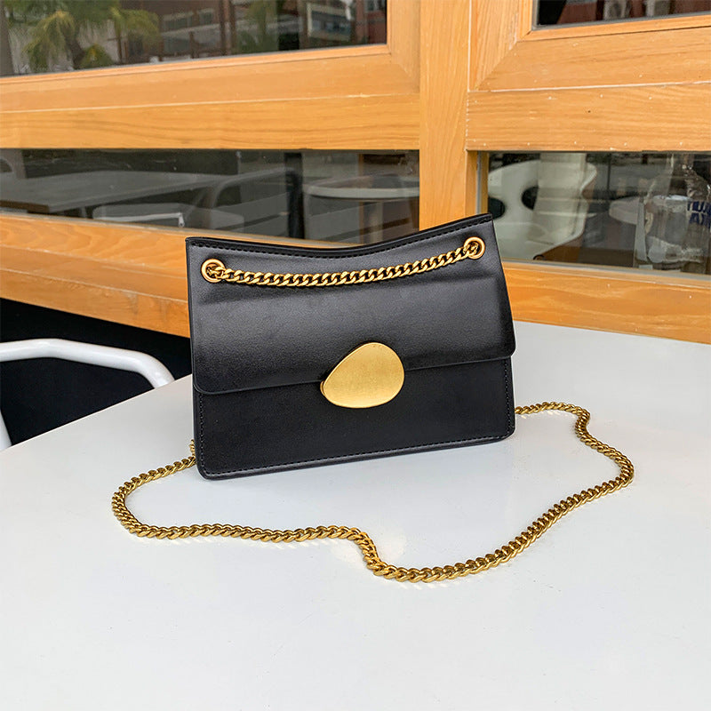 Leather one-shoulder slanted gold lock bag