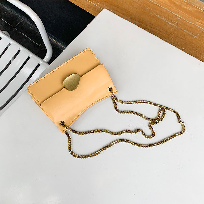 Leather one-shoulder slanted gold lock bag